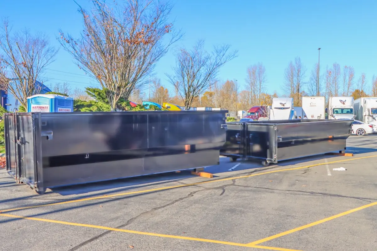 Professional dumpster rental service with roll-off container on residential driveway in Huntersville